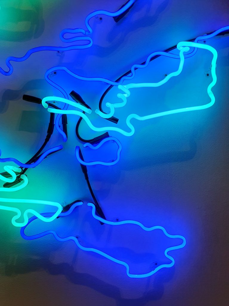 Upclose image of abstract neon shapes in different shades of blue. 