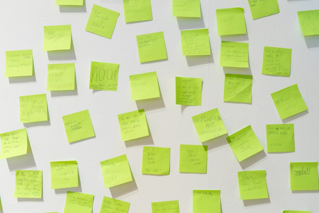 A close up image showing green post-it notes, on the wall at Salford Museum & Art Gallery